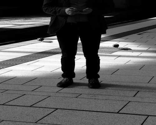Person standing comfortably waiting for transport