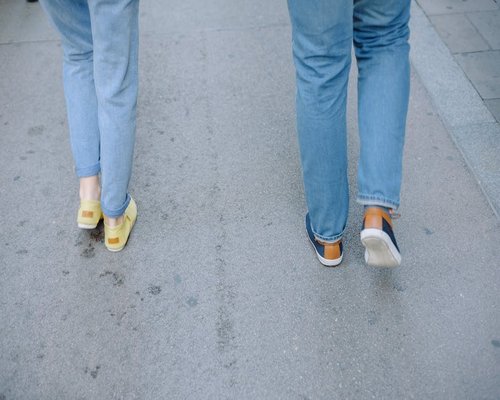 Close up of comfortable walking shoes on a city pavement